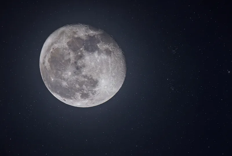 Full moon with visible craters on a black background