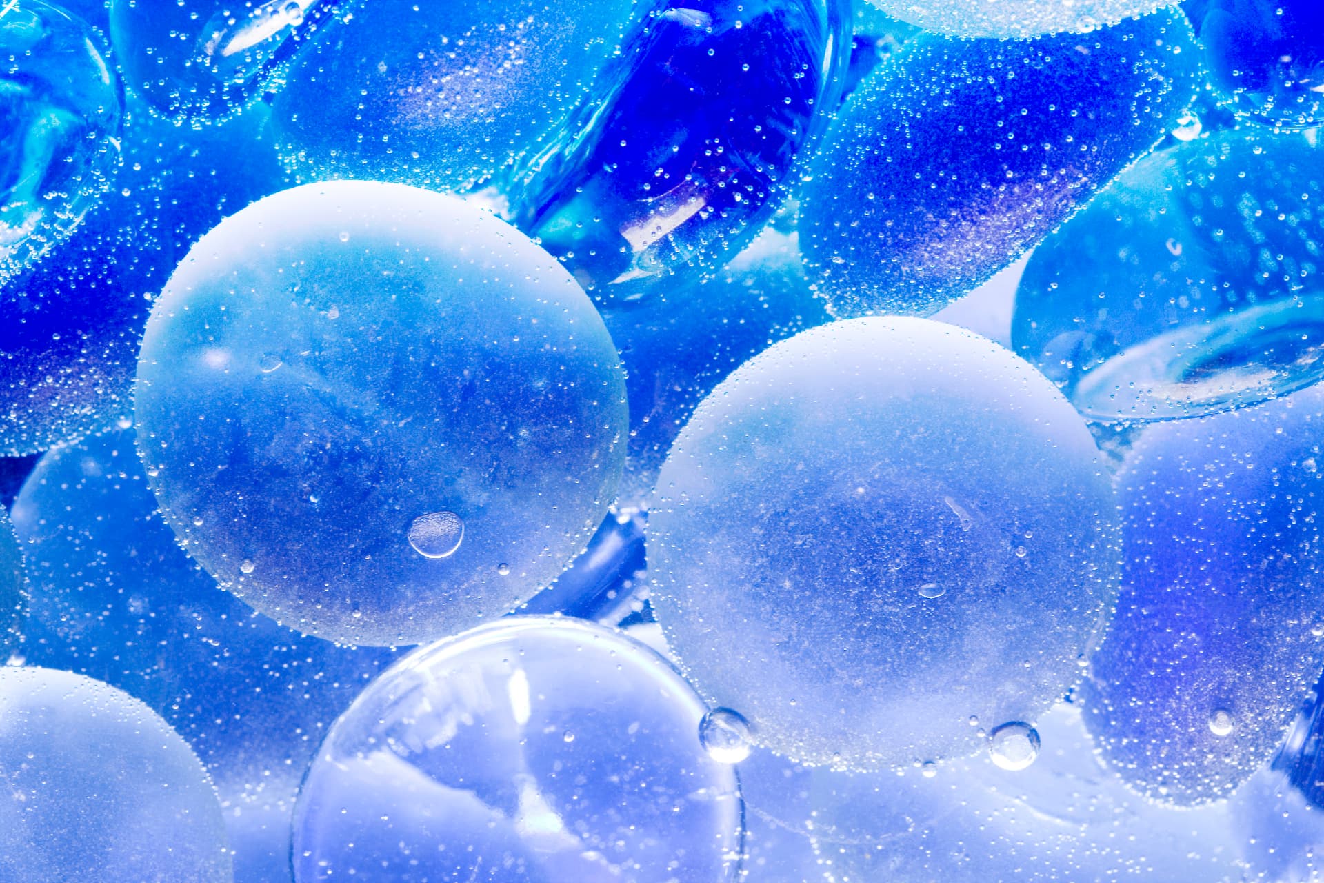 Close-up of blue glass spheres covered in water droplets