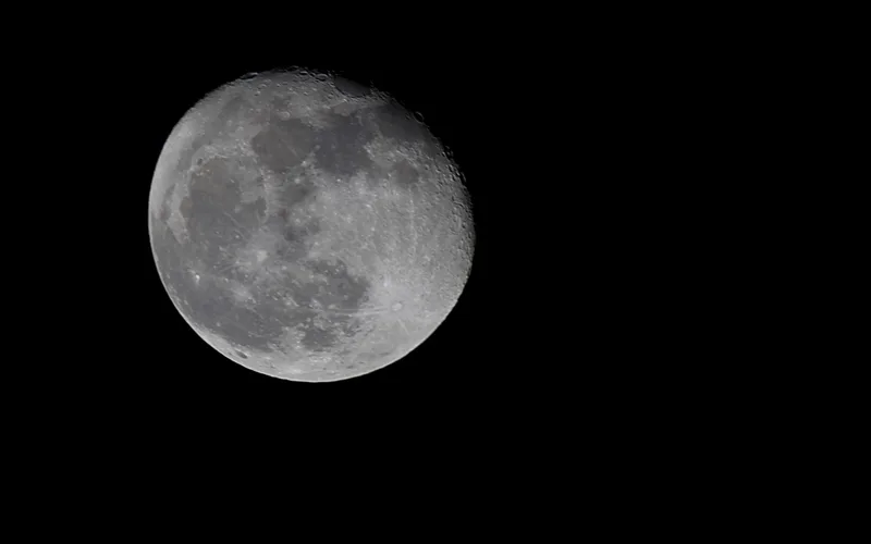 Full moon with visible craters on a black background
