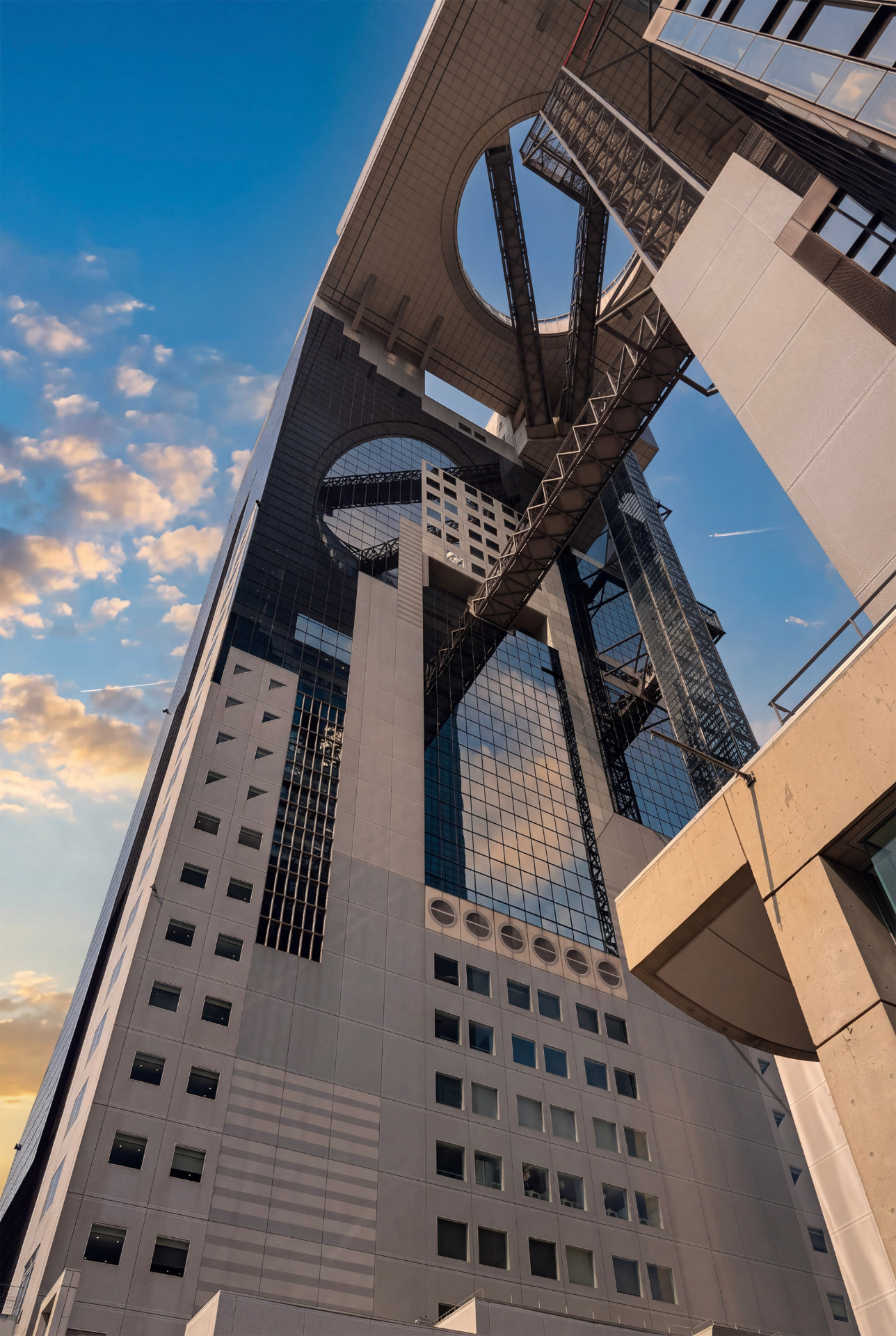 Looking up at the steel structure of a high-rise tower against a blue sky