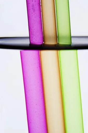 Pink, orange and green translucent tubes against a white background