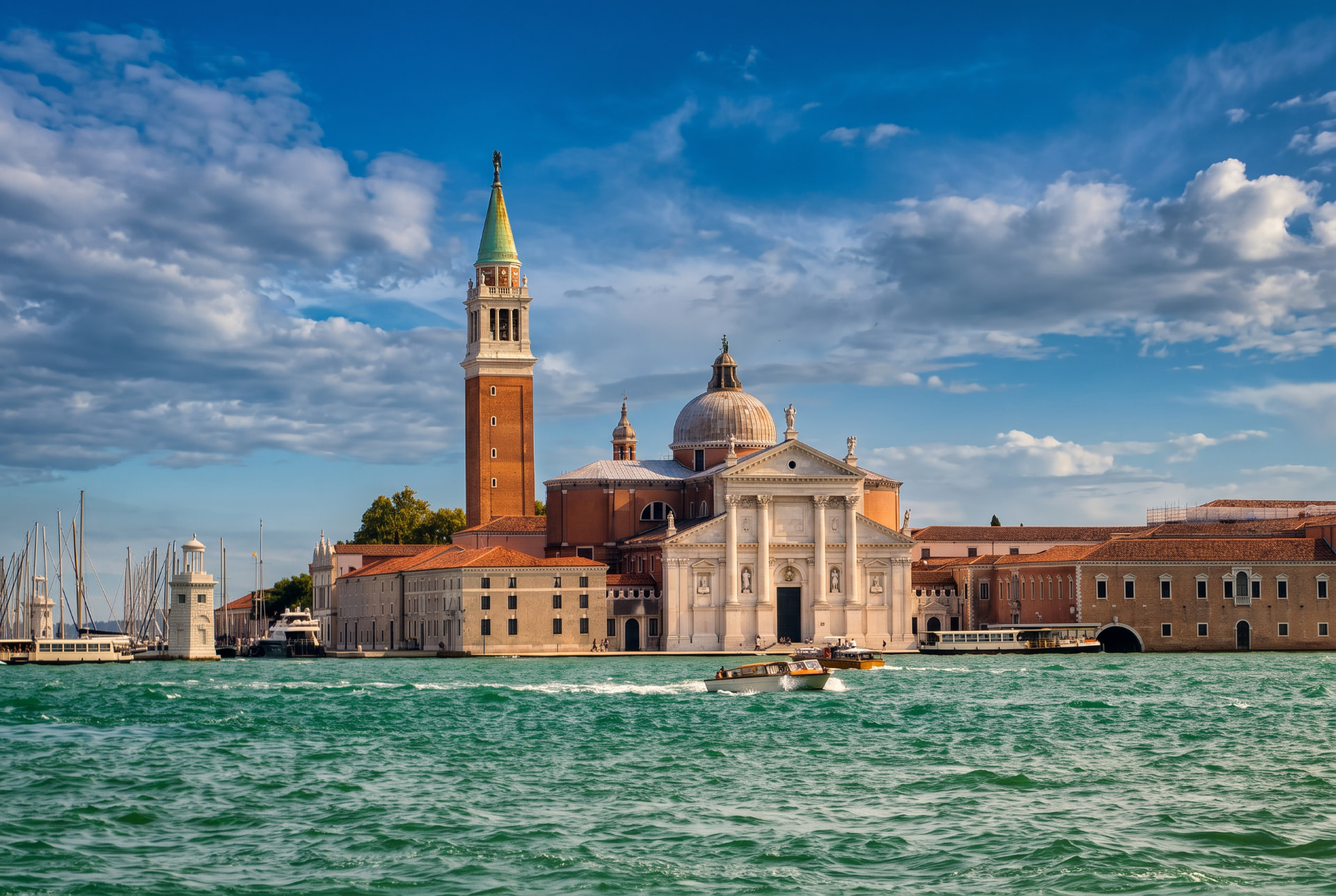 San Giorgio Maggiore church and bell tower across the Venetian lagoon with a boat on turquoise water
