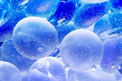 Close-up of blue glass spheres covered in water droplets