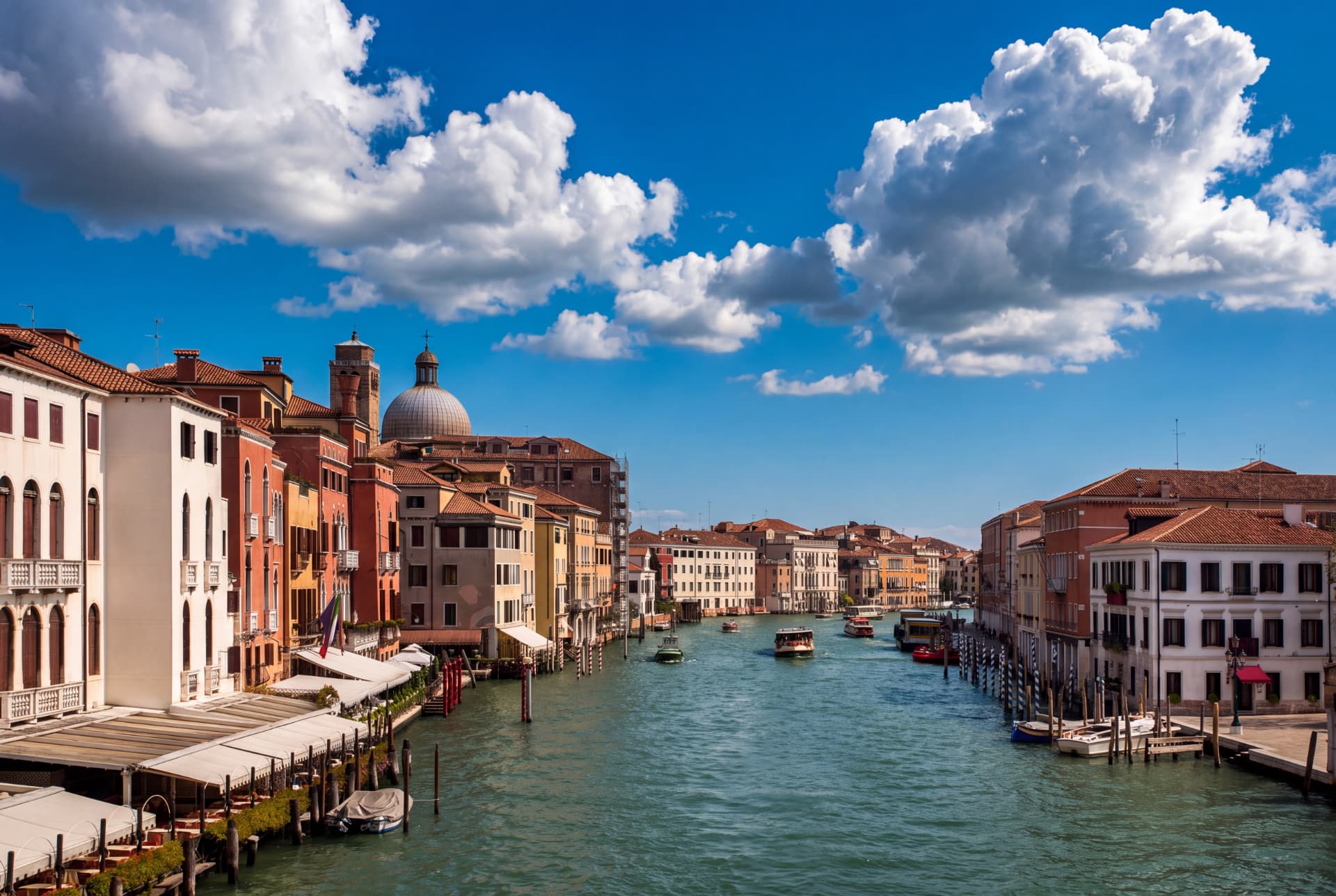 Venetian canal with historic buildings under a cloudy sky