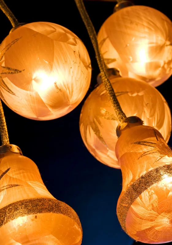 Orange glowing glass lanterns against a dark blue background