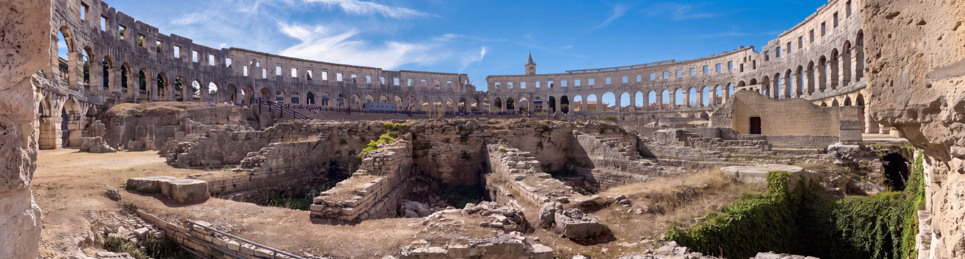 Panoramic view of the interior of the Roman amphitheatre in Pula, with its stone seating and arches